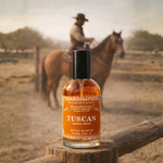 Bottle of Tuscan leather batch perfume on a wooden post with a blurred background of a person on a horse.