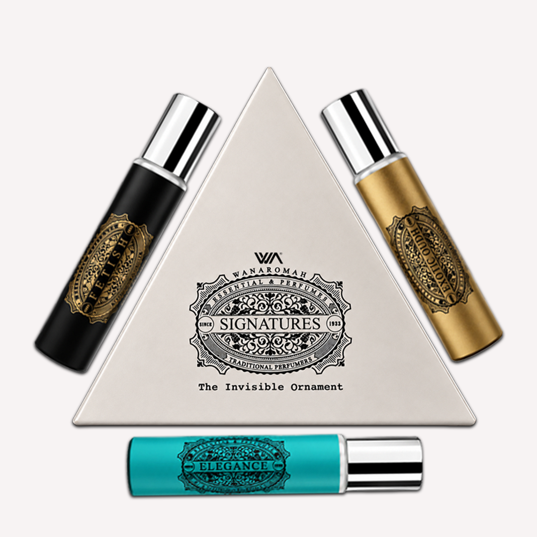 Three small bottles with labels next to a pyramid-shaped product packaging on a black background